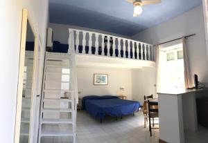 a bedroom with a bunk bed and a ladder at VisitPonza - Palazzetto Azzurro in Ponza