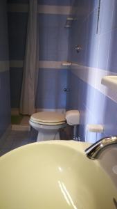 a bathroom with a white sink and a toilet at VisitPonza - Palazzetto Azzurro in Ponza