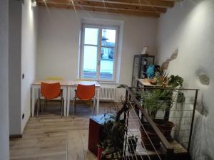 a dining room with a table and chairs and a window at YHouse 33 in Trento