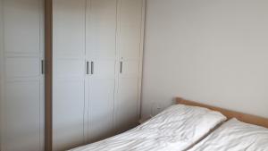 a bedroom with white cabinets and a bed at Quo Vadis Apartment in Warsaw