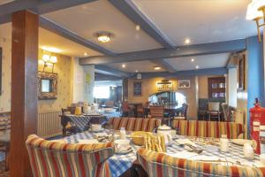 a restaurant with tables and chairs in a room at The Two Lifeboats in Sheringham