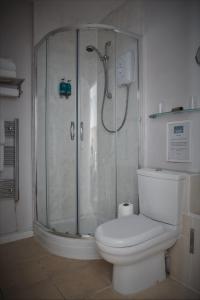 a bathroom with a shower and a white toilet at The Two Lifeboats in Sheringham