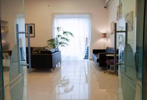 a living room with a couch and a window at Palazzo Mulada in Frattamaggiore