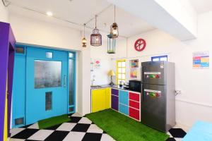 a kitchen with a refrigerator and a checkered floor at goSTOPS Mumbai in Mumbai