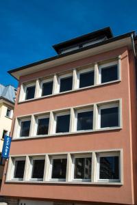 Residence Key Inn - Limperstberg في لوكسمبورغ: مبنى احمر نوافذه بيضاء من جهه