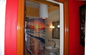 a bathroom with a shower curtain with a rainbow at Buda Apartment in Berat