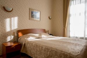
a bedroom with a bed and a dresser at Ekaterina in Pushkin
