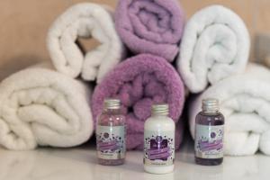 a group of purple and white towels and two bottles at Apartment Danijela II in Šibenik +44 photos