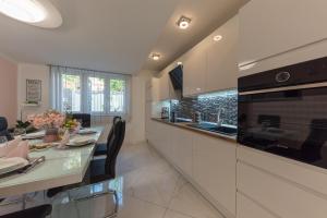 a kitchen with a dining table and a stove at Apartment Danijela II in Šibenik