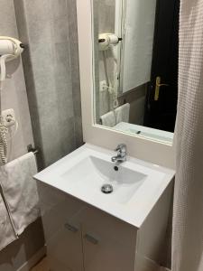 a bathroom with a white sink and a mirror at Santuario San José in San José