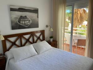 a bedroom with a bed and a view of a balcony at Santuario San José in San José