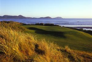 a golf course with the ocean in the background at The Links Waterville No 8 in Waterville