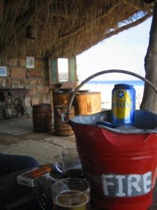 a fire bucket sitting on a table with drinks at Deep south Eco-lodge in Marsa Alam City