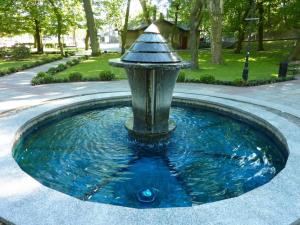 a fountain with a bird bath in a park at Apartament Paradise in Międzyzdroje