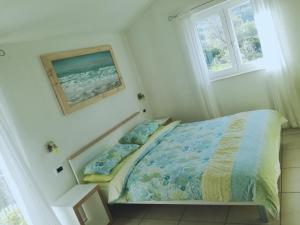 1 dormitorio con cama y ventana en Apartments Villa Ina, en Brseč