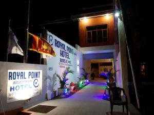 a building with a sign on the side of it at night at Royal Point Arugambay in Arugam Bay