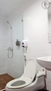 a bathroom with a toilet and a sink at Boon Street Hostel in Bangkok