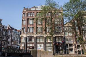 ein großes Backsteingebäude in einer Stadtstraße in der Unterkunft Dikker & Thijs Hotel in Amsterdam