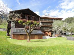 a large building with a tree in front of it at Gästehaus Taner in Virgen