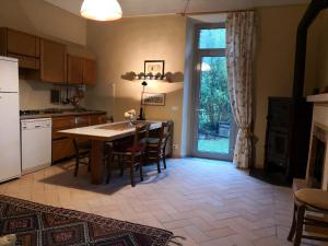a kitchen with a table and chairs and a dining room at San Giovannina '800 in Casale Monferrato
