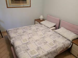 a bedroom with a bed with a quilt on it at San Giovannina '800 in Casale Monferrato