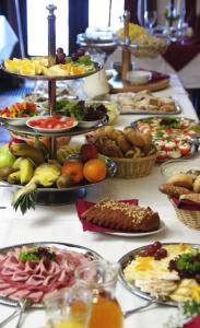 a table filled with lots of different types of food at Park Hotel Pruhonice in Pruhonice