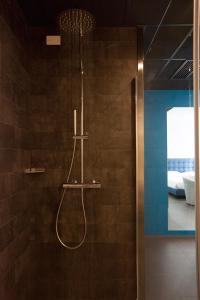 a shower in a bathroom with a shower at Hotel Carnia in Venzone