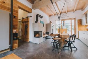 a living room with a fireplace and a table and chairs at Luxus-Chalet am Fluss in Schwarzach bei Nabburg