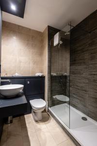 a bathroom with a toilet and a sink and a shower at Fir Trees Hotel in Strabane