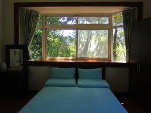 Postel nebo postele na pokoji v ubytování Shin-Liu Garden B&B
