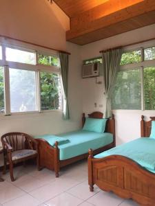 Postel nebo postele na pokoji v ubytování Shin-Liu Garden B&B