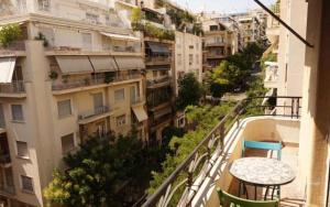 a view from a balcony of a building with a table at Spacious & Sunny Kolonaki Apt 5 mins metro/ACx3/1.5 BT in Athens