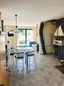 a kitchen and dining room with a table and chairs at "Backbord" by Ferienhaus Strandgut in Born