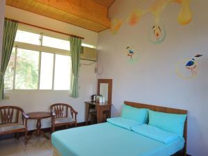 Postel nebo postele na pokoji v ubytování Shin-Liu Garden B&B