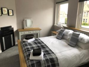 a bedroom with a bed and a tv on a table at Old Police House Causewayhead Stirling in Stirling