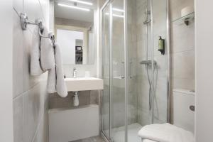 a bathroom with a shower and a sink and a toilet at Hôtel Alcôve Nice in Nice