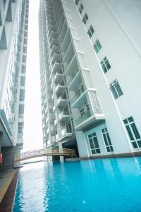 an apartment building with a swimming pool in front of it at Ksl City Mall D'esplanade By The one in Johor Bahru