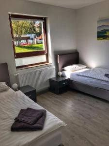 a bedroom with two beds and a window at Freizeitcenter Bad Sachsa in Bad Sachsa