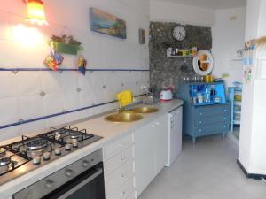 a kitchen with a sink and a stove top oven at Casa Formis in Levanto