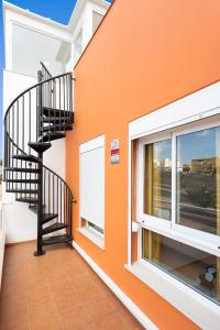 a balcony with a staircase in a house at Home2Book Beautiful Duplex Arona in Arona