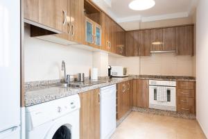 a kitchen with a sink and a dishwasher at Home2Book Beautiful Duplex Arona in Arona