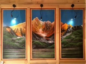 a mural of a mountain seen through a window at The blue mountains on the moon in Shangri-La