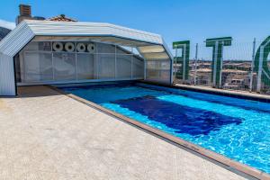 a swimming pool on the roof of a building at KAKTUS Hotel Kaktus Albir in Albir