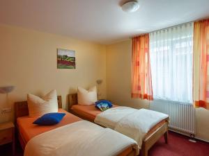 a hotel room with two beds and a window at Obst- und Ferienhof Gomeringer in Immenstaad am Bodensee