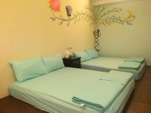 Postel nebo postele na pokoji v ubytování Shin-Liu Garden B&B