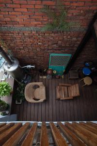 an overhead view of a wooden deck with benches at May Rooms Taipei Nangang Station in Taipei