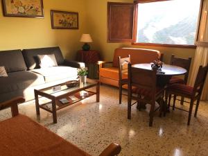 a living room with a couch and a table at HOUSES CASA LA TOSCA The Best views in Tejeda