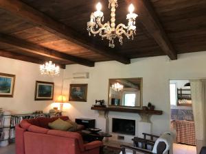 a living room with a couch and a chandelier at Villa Giulia in Lecce