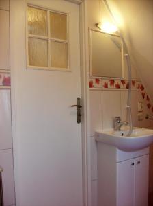 a bathroom with a sink and a mirror at Apartamenty Domek Myśliwski in Karpacz +65 photos