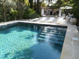 a swimming pool with blue water in a backyard at Villa Giulia in Lecce